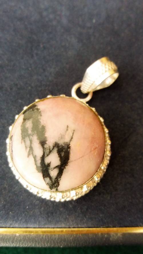 A Genuine Round Pink Rhodonite Stone And Silver Metal Pendant