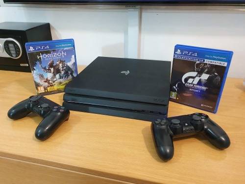 Playstation 4 Pro Console + 2 Wireless Remotes + 2 Games