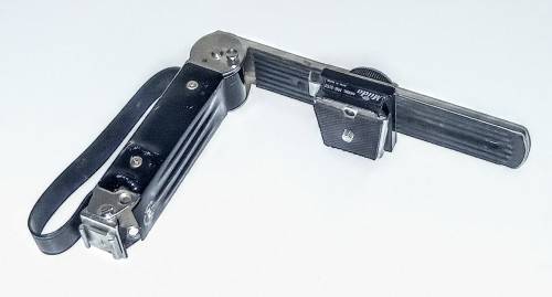 Vintage camera foldable grip with acc shoe mount.