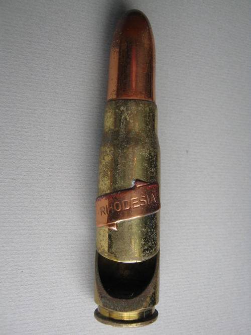 BOTTLE OPENER WITH A "RHODESIA" PLAQUE ON IT MADE FROM A 20mm "doppie"