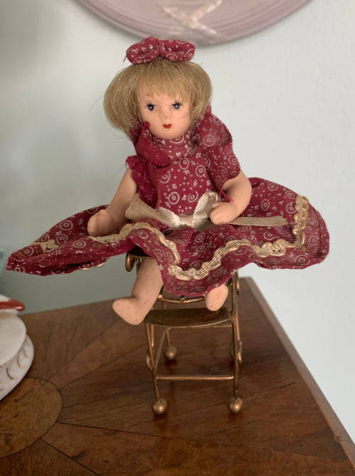 Doll on metal high Chair