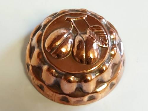 THREE VINTAGE COPPER JELLY MOULDS WITH A FRUIT MOTIF