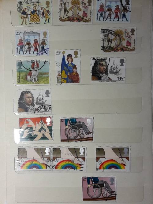STAMP ALBUM WITH 230 STAMPS