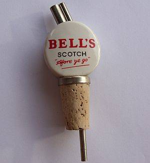 A VINTAGE CERAMIC ADVERTISING SPIRITS POURER