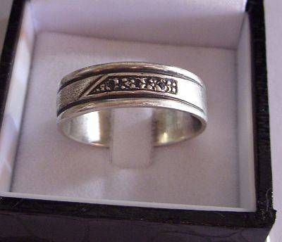A LARGE STERLING SILVER BAND WITH 3 MINI DIAMONDS