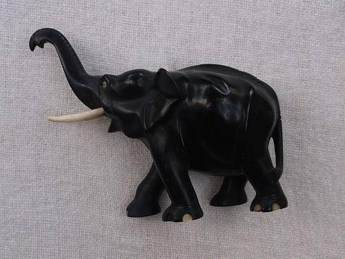 A MARVELOUS VINTAGE SOLID WOOD ELEPHANT CARVING WITH GENUINE BONE TUSKS AND INLAYS ....NICE !!