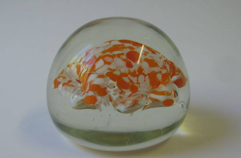 A COOL LOOKING VINTAGE SOLID GLASS PAPERWEIGHT WITH WHITE AND ORANGE SPECKLES DETAIL...NICE !!