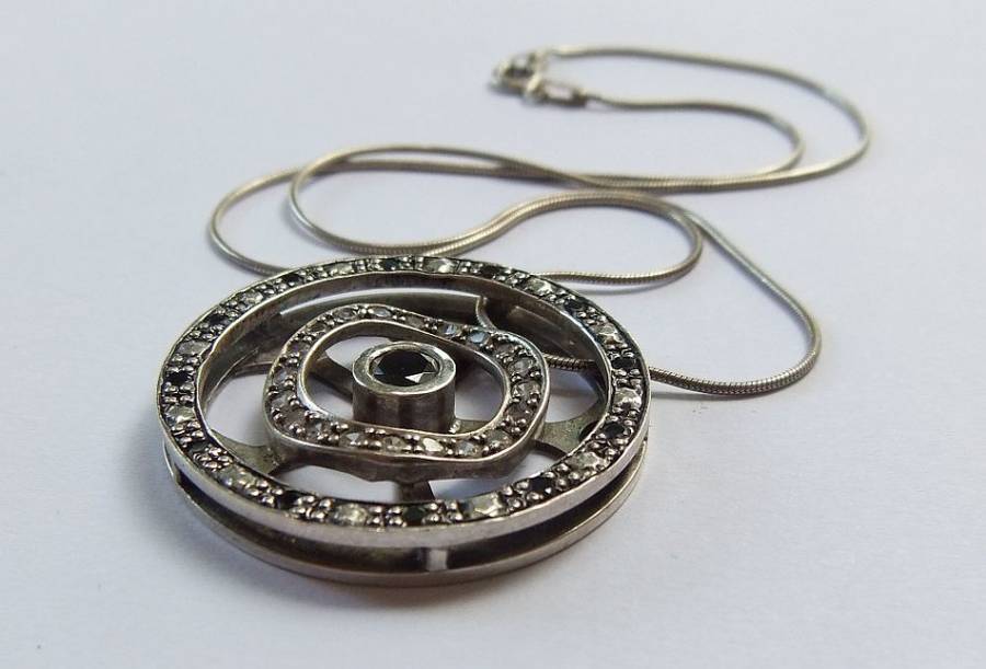 A STYLISH STERLING SILVER "WHEEL" PENDANT SET WITH VARIOUS STONES PLUS A STERLING SILVER NECKLACE !!