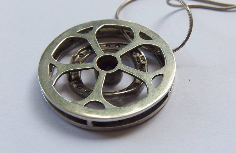 A STYLISH STERLING SILVER "WHEEL" PENDANT SET WITH VARIOUS STONES PLUS A STERLING SILVER NECKLACE !!