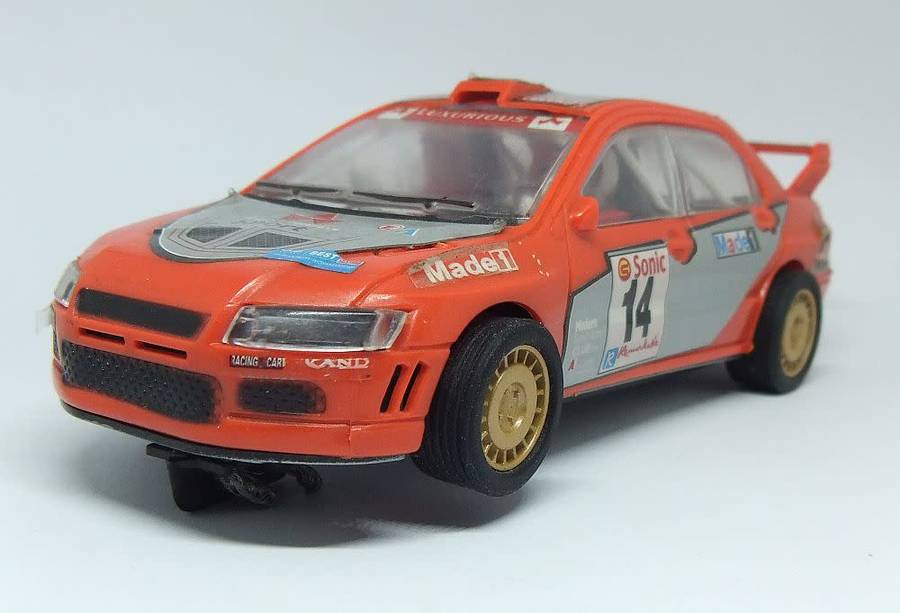 A vintage scalextric car with advertising , driver with co-driver aka navigator