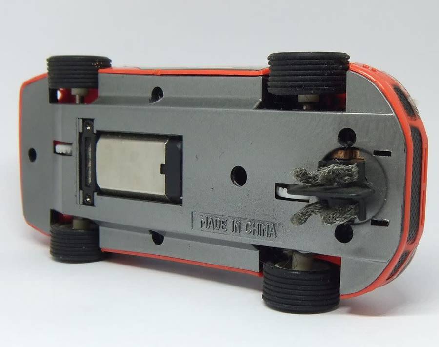 A vintage scalextric car with advertising , driver with co-driver aka navigator