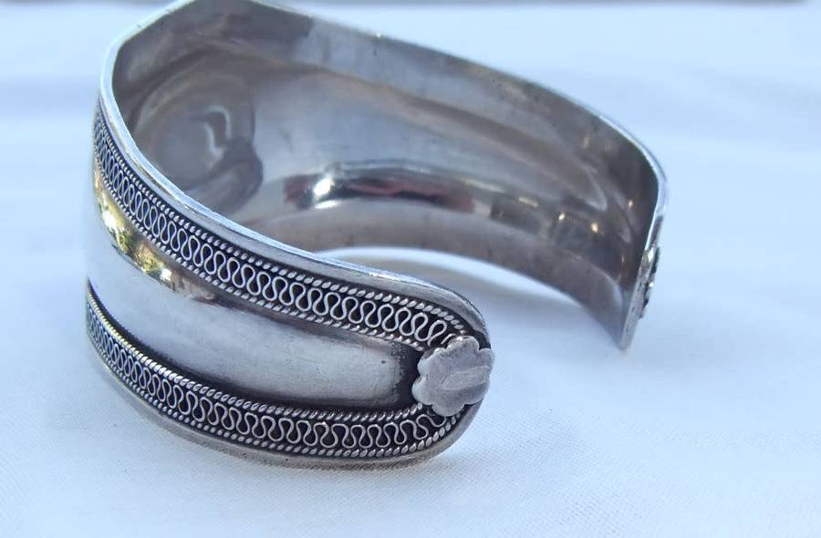 A solid sterling silver cuff bangle with a green cabochon inset - stamped & tested