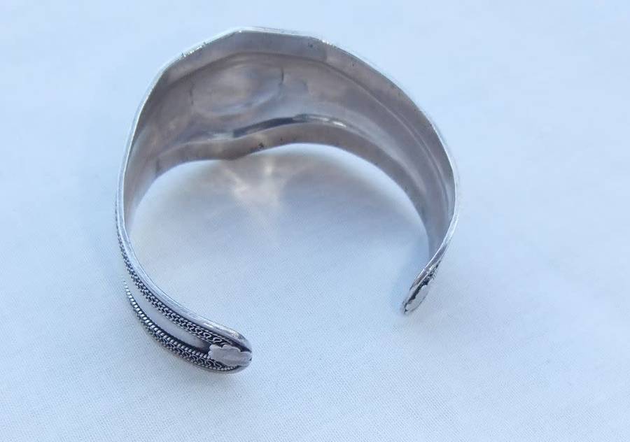 A solid sterling silver cuff bangle with a green cabochon inset - stamped & tested