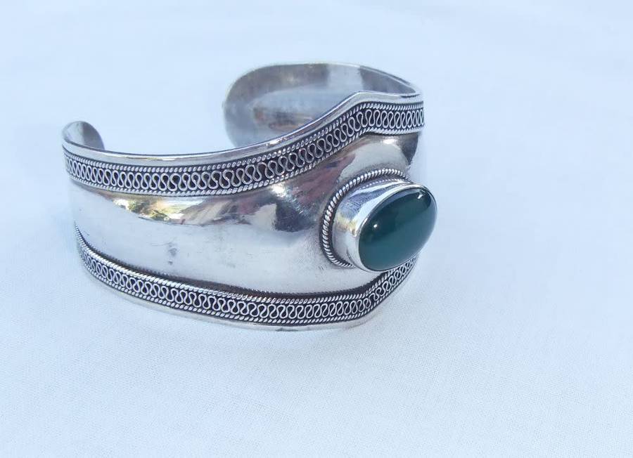 A solid sterling silver cuff bangle with a green cabochon inset - stamped & tested