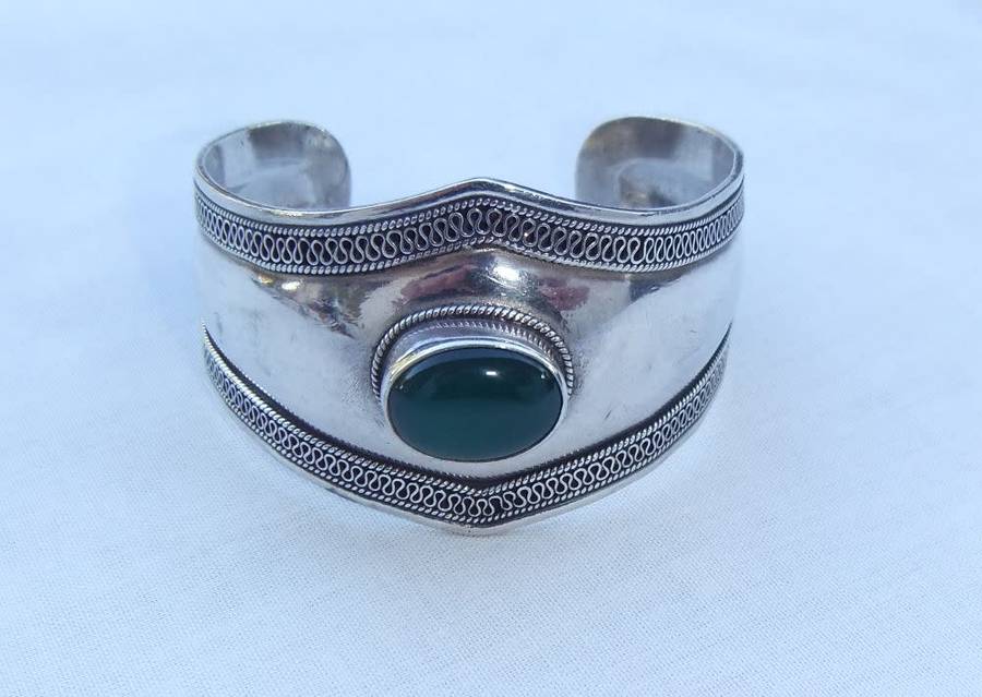 A solid sterling silver cuff bangle with a green cabochon inset - stamped & tested