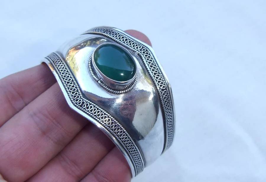 A solid sterling silver cuff bangle with a green cabochon inset - stamped & tested