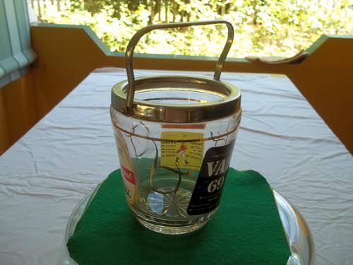 Vintage glass ice bucket with silver plated rim and handle with logos of whiskey on