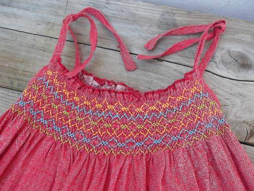 Dark orange dress for little girl by 'Etafeni', shweshwe material with smocking detail, size 6yrs