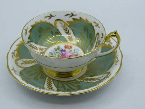 PARAGON VINTAGE GILDED AND SAGE-GREEN FOOTED TEA CUP AND SAUCER WITH CABBAGE ROSES.
