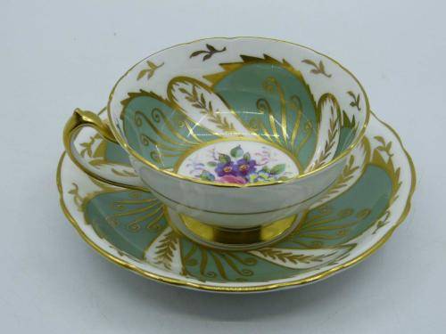 PARAGON VINTAGE GILDED AND SAGE-GREEN FOOTED TEA CUP AND SAUCER WITH CABBAGE ROSES.