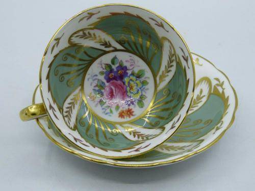 PARAGON VINTAGE GILDED AND SAGE-GREEN FOOTED TEA CUP AND SAUCER WITH CABBAGE ROSES.