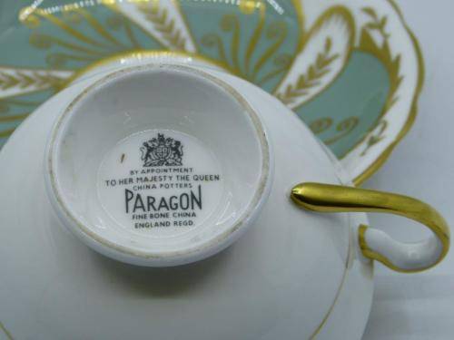 PARAGON VINTAGE GILDED AND SAGE-GREEN FOOTED TEA CUP AND SAUCER WITH CABBAGE ROSES.