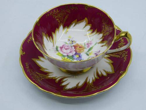 PARAGON GILDED AND CARDINAL RED VINTAGE TEA CUP DUO WITH CABBAGE ROSES .