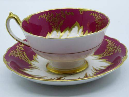 PARAGON GILDED AND CARDINAL RED VINTAGE TEA CUP DUO WITH CABBAGE ROSES .