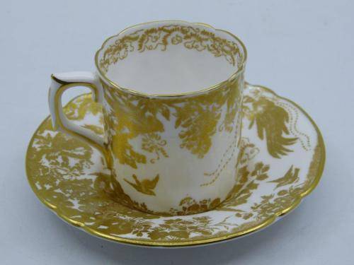 ROYAL CROWN DERBY DEMI TASSE AND SAUCER IN THE GOLD AVES  PATTERN.