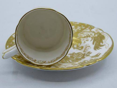 ROYAL CROWN DERBY DEMI TASSE AND SAUCER IN THE GOLD AVES  PATTERN.