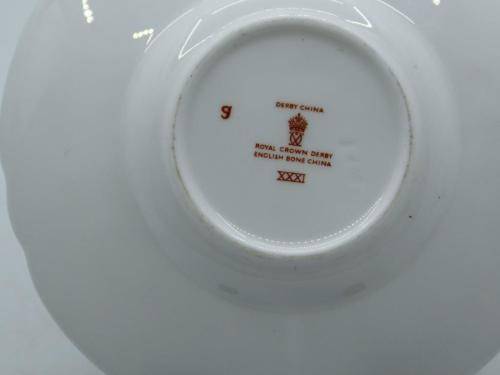 ROYAL CROWN DERBY DEMI TASSE AND SAUCER IN THE GOLD AVES  PATTERN.
