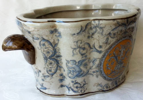 LARGE, HEAVY PORCELAIN, POT PLANT HOLDER WELL DECORATED WITH LEAVES, FLOWERS AND AN ANGEL OR TWO !!!