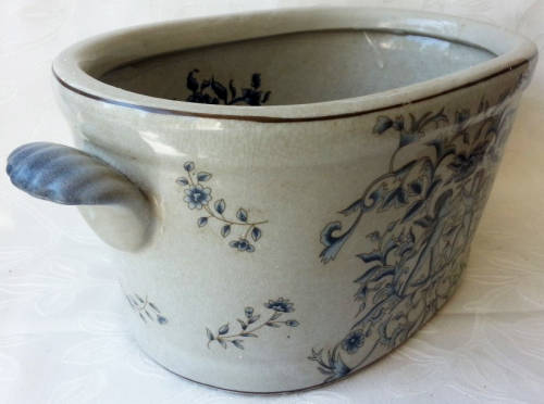 LARGE, HEAVY PORCELAIN, POT PLANT HOLDER WELL DECORATED WITH LEAVES, FLOWERS AND AN ANGEL OR TWO !!!