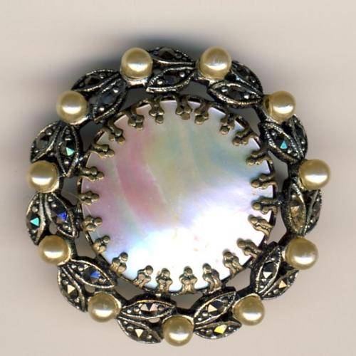 Antique brooch with mother of pearl center