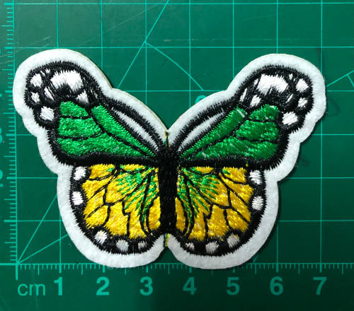 Bufferfly patch in green and yellow on white