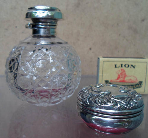HALLMARKED EMBOSSED SILVER PILL BOX AND SILVER TOP SCENT BOTTLE