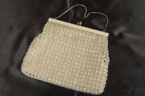 Silver raffia weave type evening bag with its own storage pouch