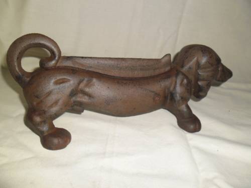 Cast iron sausage dog boot scraper or door stop