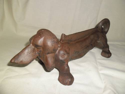 Cast iron sausage dog boot scraper or door stop
