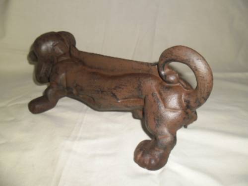 Cast iron sausage dog boot scraper or door stop