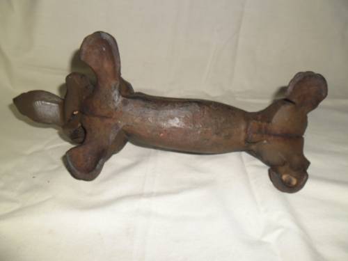 Cast iron sausage dog boot scraper or door stop