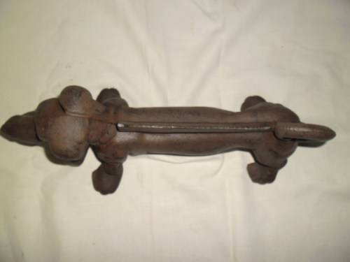 Cast iron sausage dog boot scraper or door stop