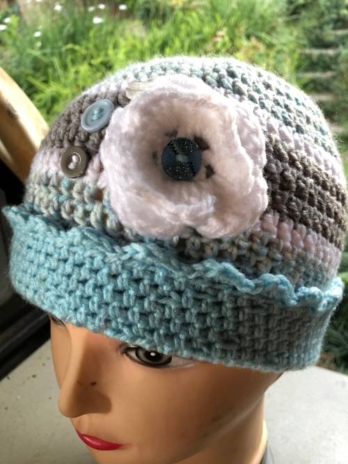 Unique handmade crochet beanie with flower and buttons detail in blue