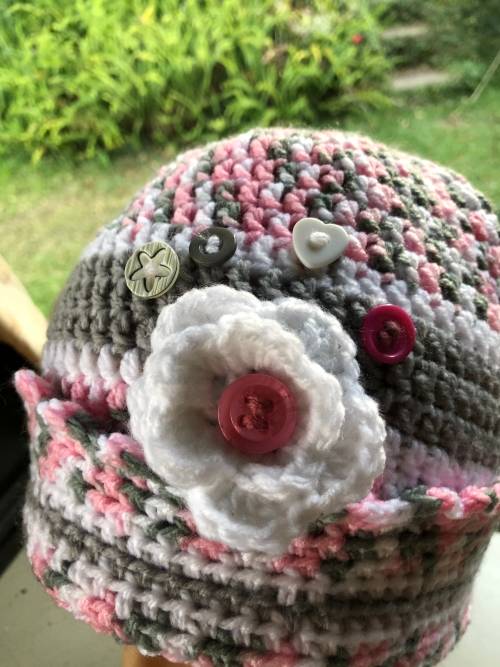 Unique handmade crochet beanie with flower and buttons detail in pink
