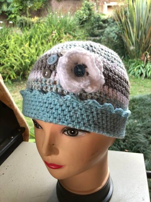 Unique handmade crochet beanie with flower and buttons detail in blue