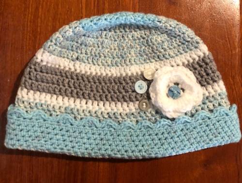 Unique handmade crochet beanie with flower and buttons detail in blue