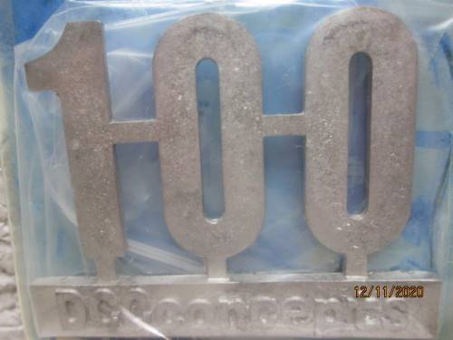 REDUCED TO CLEAR : DCC CONCEPTS : `100` WHITE METAL BADGE