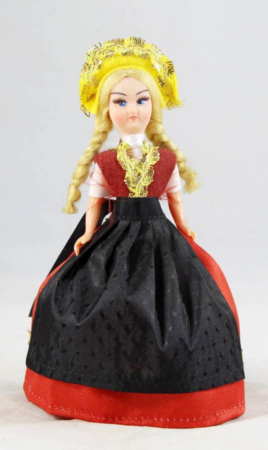 Girl with braids in traditional dress doll