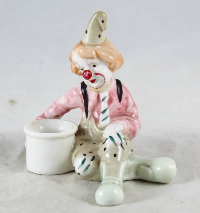 Small Clown Sitting Next To Drum