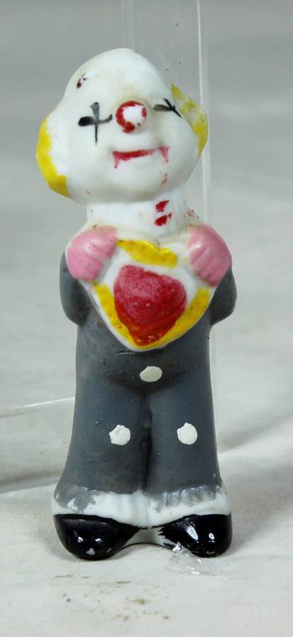 Miniature clown holding a heart